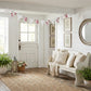 Cozy living room with floral bunting, white sofa, and decorative elements.