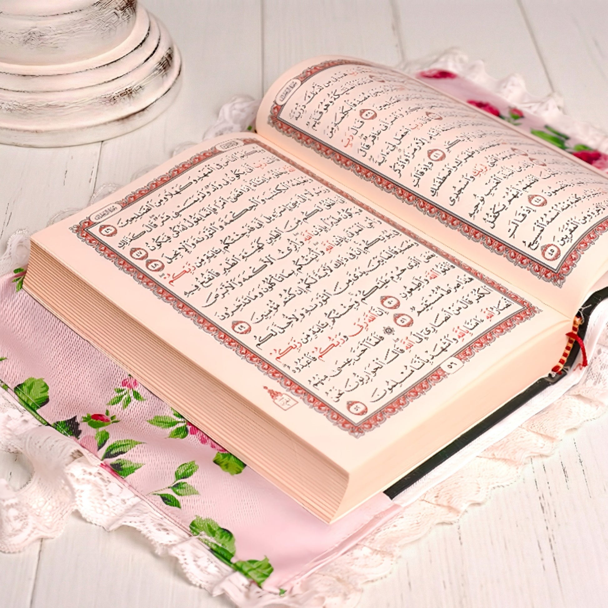 Open book with text on a floral fabric background