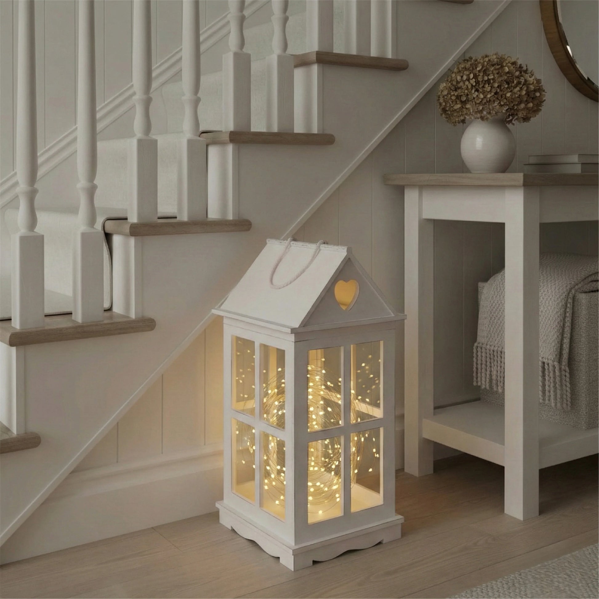 Decorative lantern with glowing interior lights placed under a staircase.