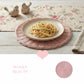 Round Wicker Placemat in pink with pasta plate on floral tablecloth for dining table setting