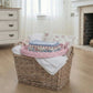 Round Wicker Tray placed with folded clothes on wooden floor near fireplace for home décor storage styling