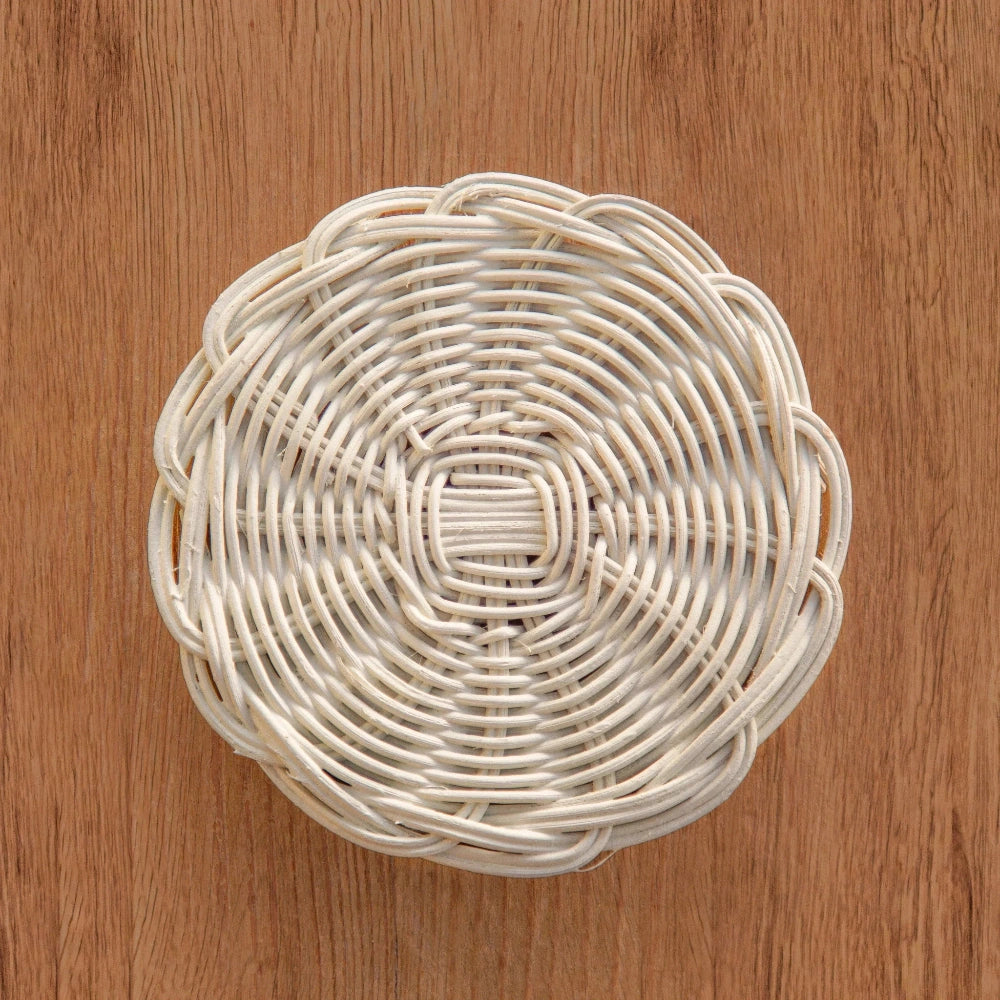 Round woven basket on a wooden surface