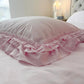 Ruffled Bedding Set in pale pink with ruffled pillowcase styled in a shabby chic bedroom