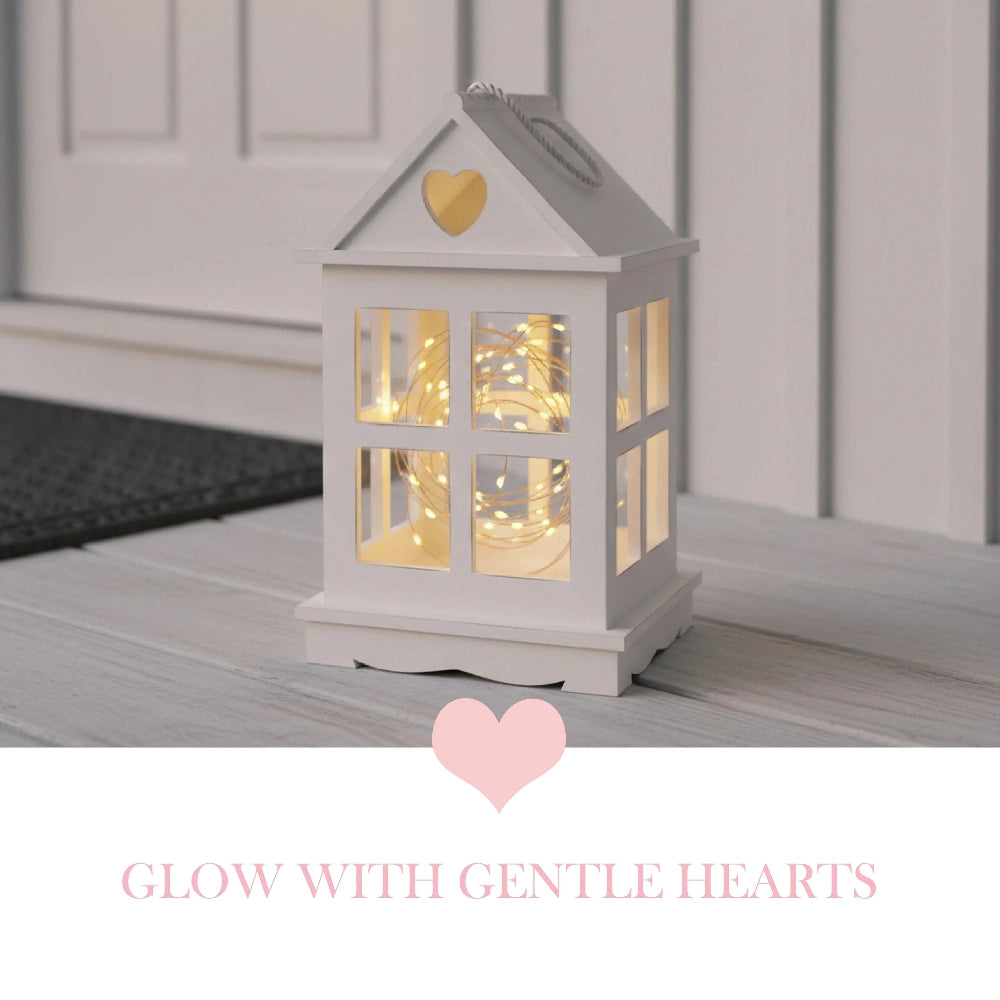 Rustic Wooden Heart Cut-Out Lantern on floor displaying heart-shaped cutouts and warm candle glow