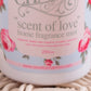 Home fragrance mist labeled 'scent of love' with floral design on a light background