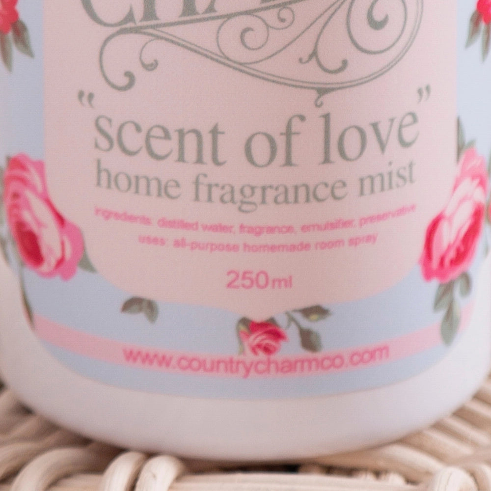 Home fragrance mist labeled 'scent of love' with floral design on a light background