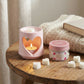 Scent of Love home fragrance soy wax melts on a wooden table next to a pink ceramic heart burner.