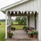 Shabby Chic Fleur & Polka Dot Pennant Banner Flag with pink rose floral and beige polka dot patterns hanging on a white wooden farmhouse porch.