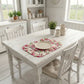 Fleur print ruffled placemat with a dinner plate and cutlery set on a white distressed farmhouse dining table.