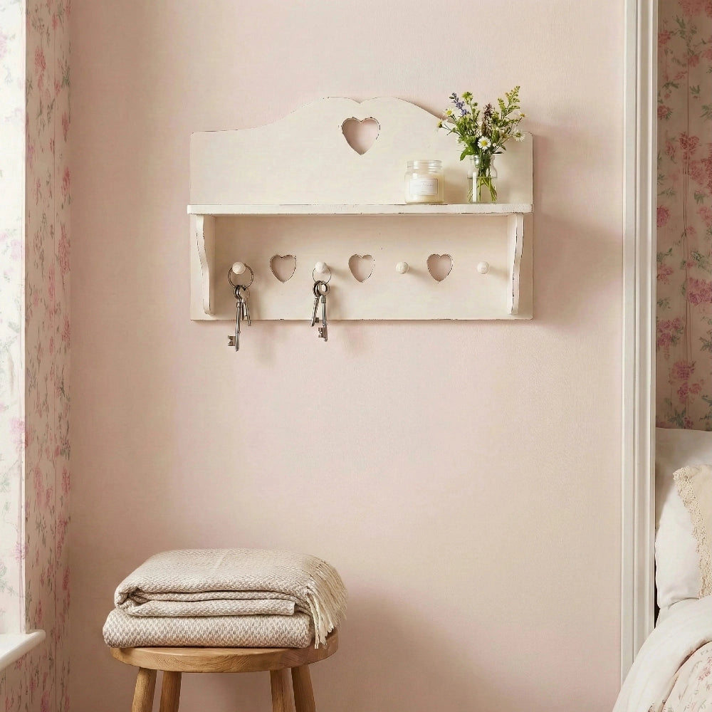 Shabby Chic Heart Cut-Out Wall Shelf with hooks and small plant display in bedroom