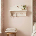 Shabby Chic Heart Cut-Out Wall Shelf with hooks and small plant display in bedroom
