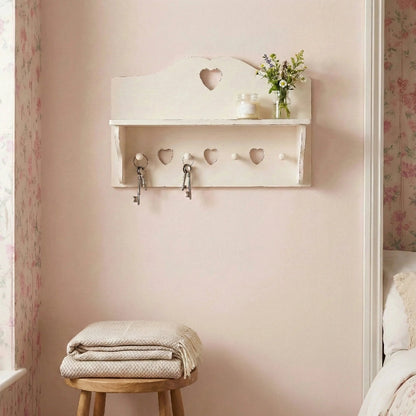 Shabby Chic Heart Cut-Out Wall Shelf with hooks and small plant display in bedroom