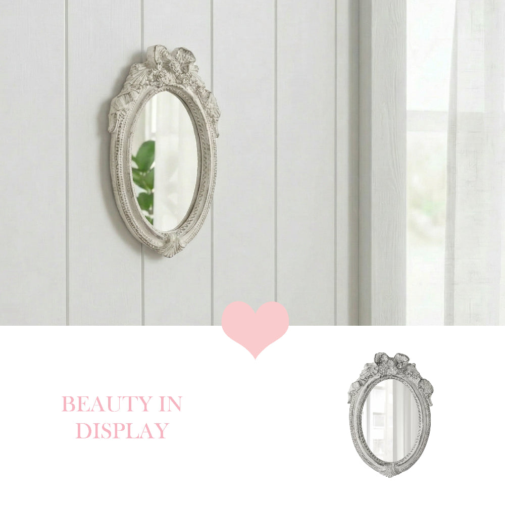 Ornate white ribbon mirror mounted on a white wood paneled wall with a pink heart icon and "Beauty in Display" text.