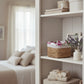 Shelving unit in bedroom displaying decorative items and organized home decor accessories