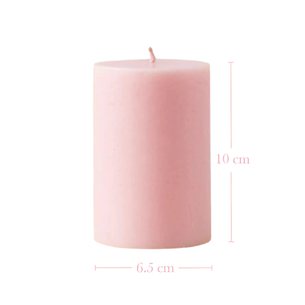 Pink pillar candle with dimension lines showing a height of 10 cm and a width of 6.5 cm.