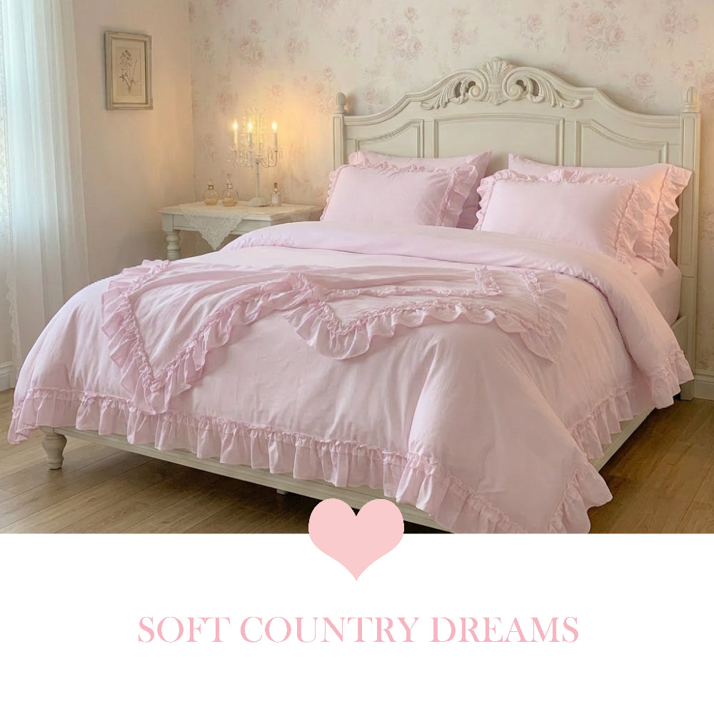 Pale pink ruffled bedding on an ornate white bed frame with "Soft Country Dreams" text and a pink heart icon below.