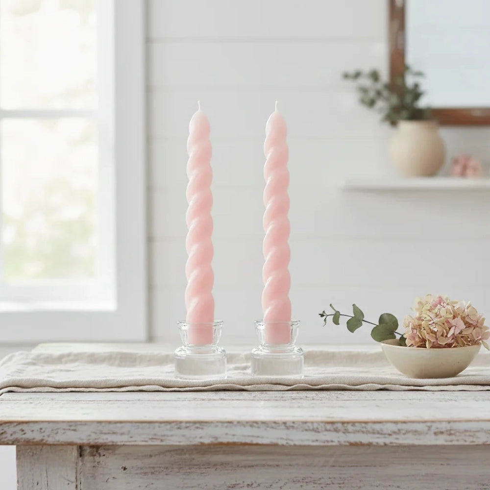 Twister Dinner Candles in two pink glass holders displayed on a wooden table