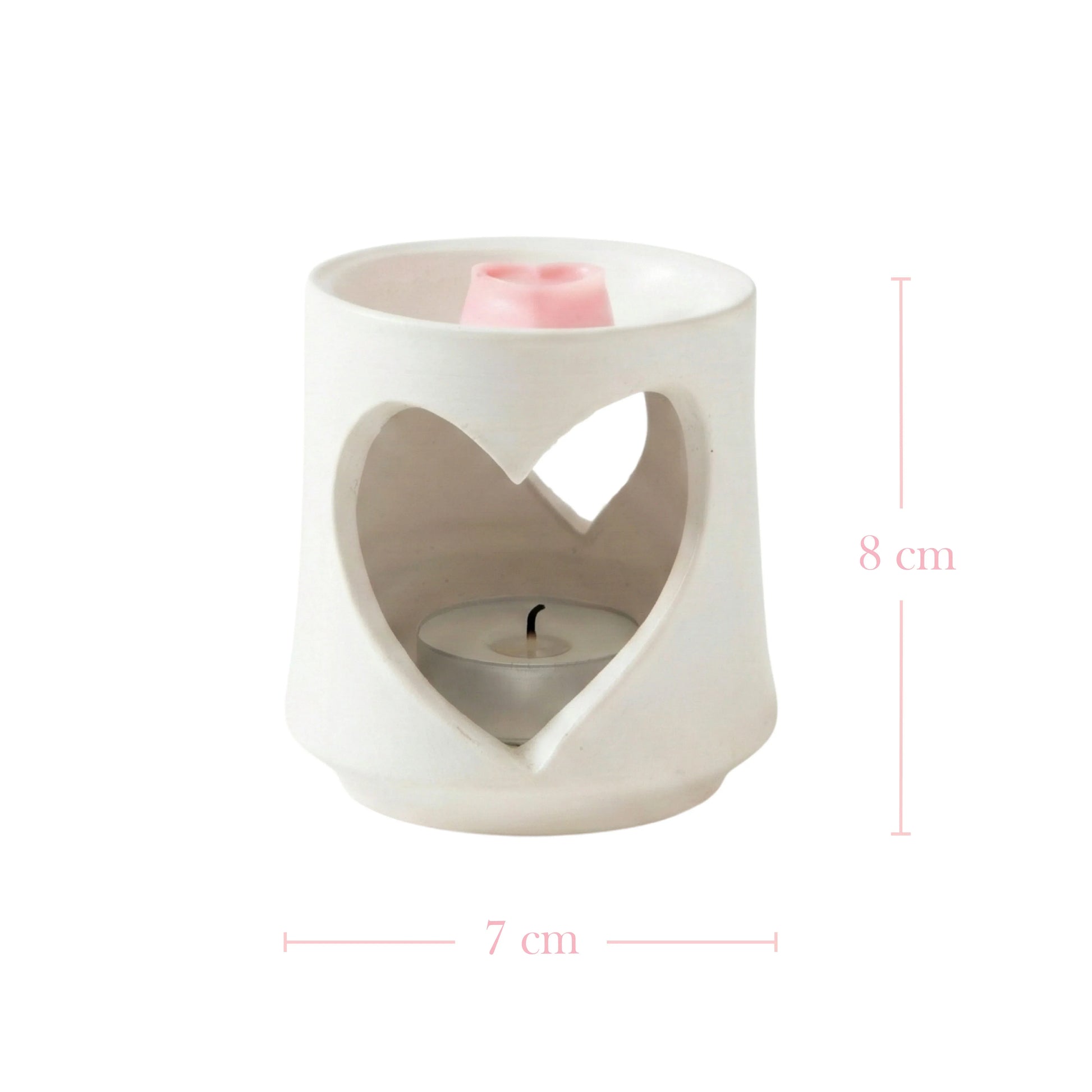 White ceramic oil burner with heart-shaped design on a white background

