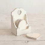 White heart-shaped coasters in distressed wooden holder with heart cutout displayed on light wood surface for home decor