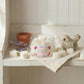 White heart shaped wax melts scattered next to an open jar of Scent of Love home fragrance wax melt.
