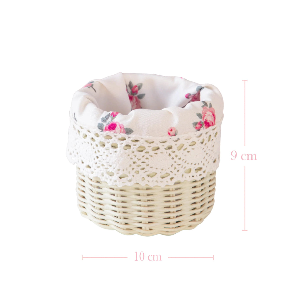 White wicker basket with floral lining and lace trim, with dimensions of 12 cm height and 12 cm width.