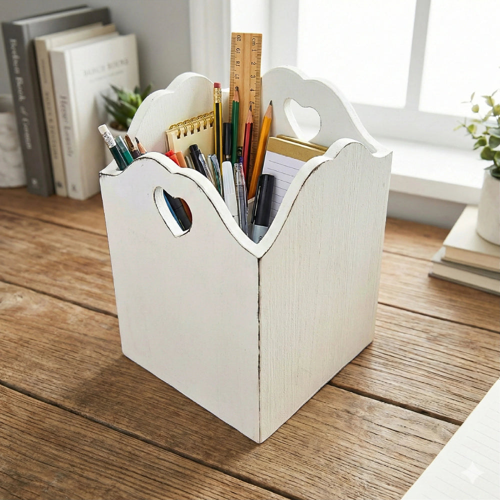 White wooden basket with a heart cutout handle and stationery items in it on a wooden surface