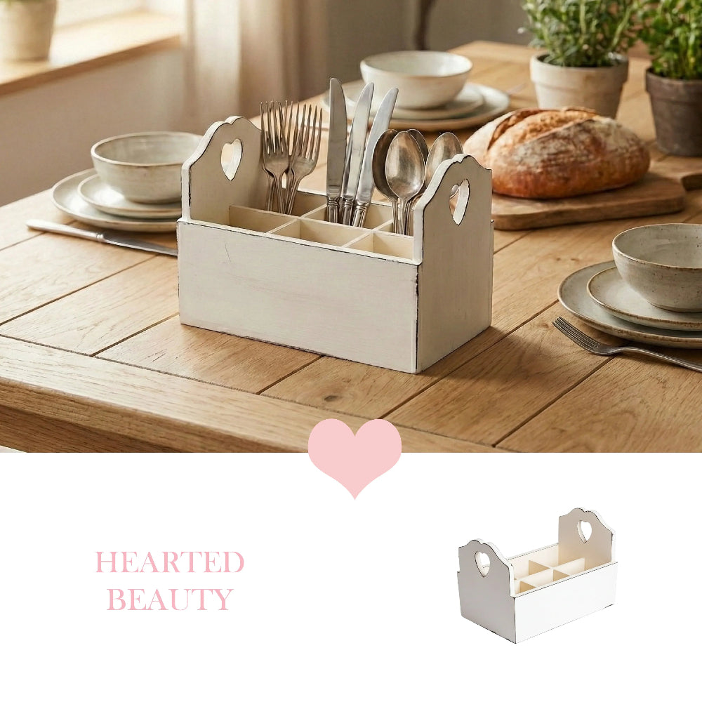 Antique white wooden cutlery caddy with six compartments and heart side handles, styled on a farmhouse dining table.