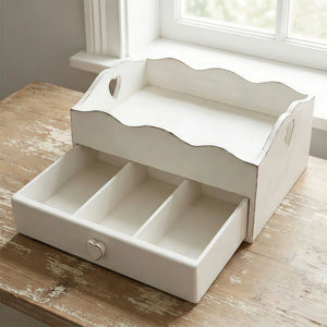 Shabby chic white wooden desk organizer with a heart-shaped drawer pull and scalloped edges on a rustic wooden table.