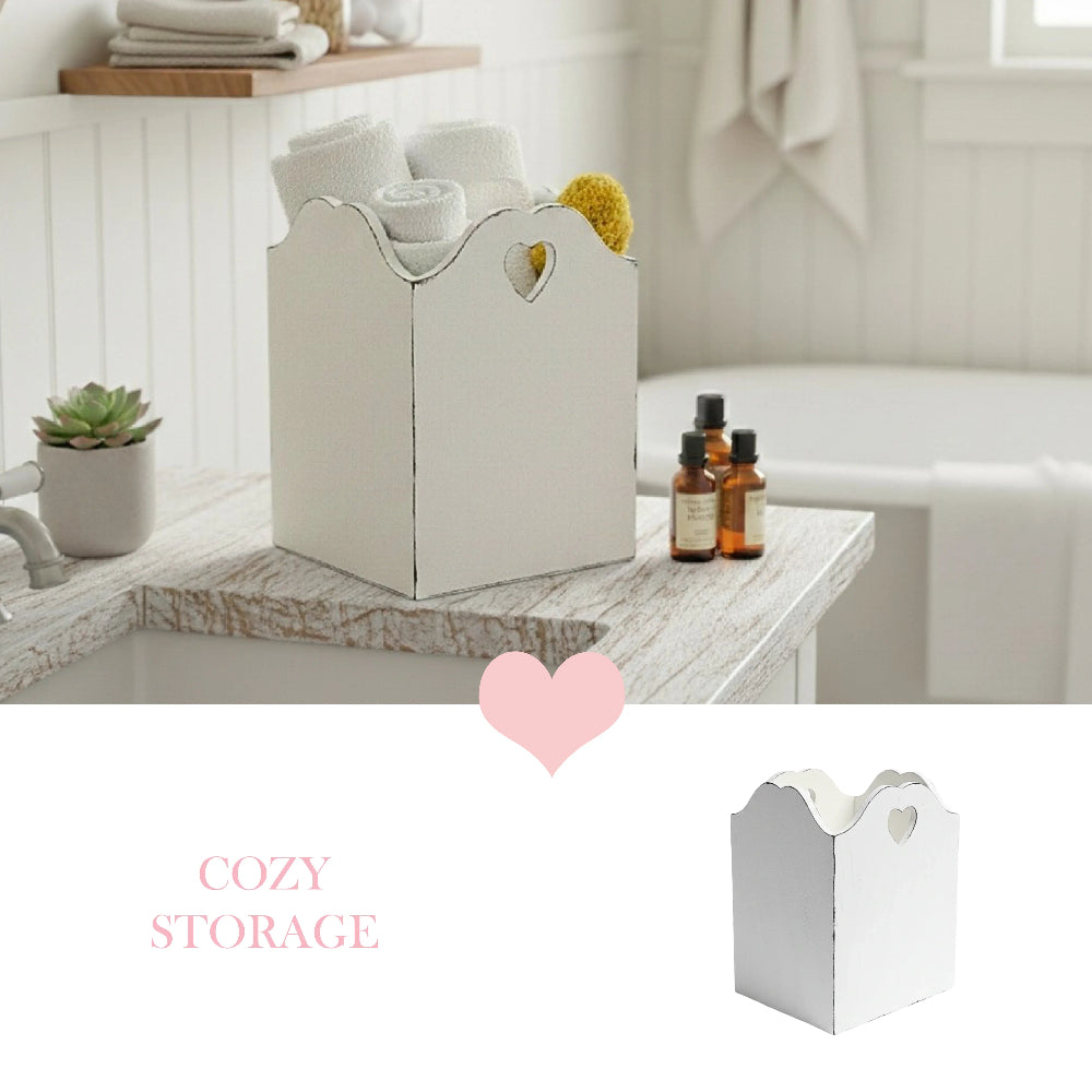 White wooden storage basket with heart cutouts on a wooden surface, surrounded by small bottles and a plant, with 'Cozy Storage' text.
