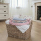 Round Woven Tray on a Wicker laundry basket with folded clothes and a wooden floor in a room with a fireplace