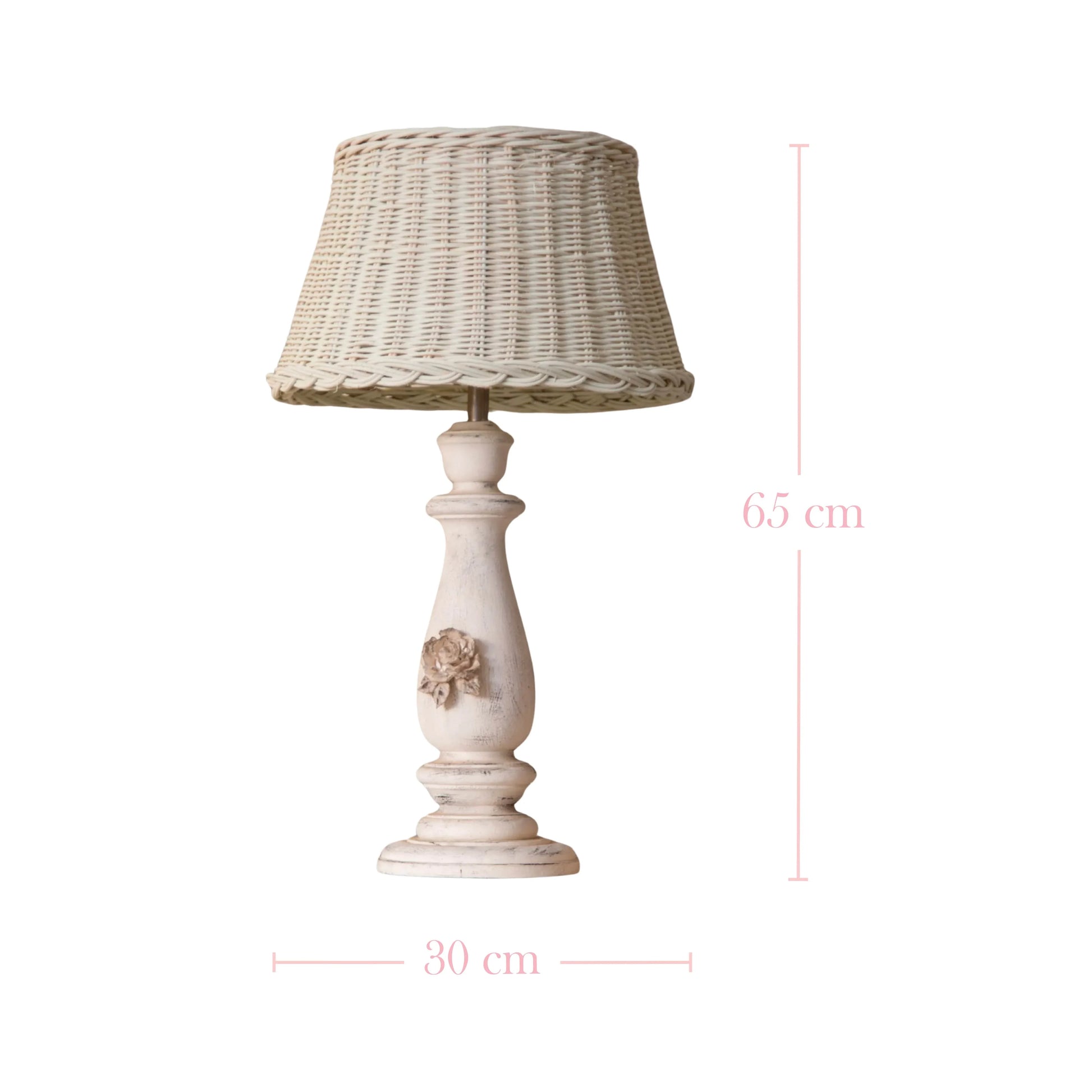 Table lamp with wicker shade and decorative base on a white background